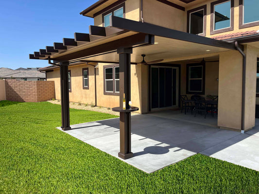 Brown patio cover with grass backyard. An alumatable is installed on the patio cover post